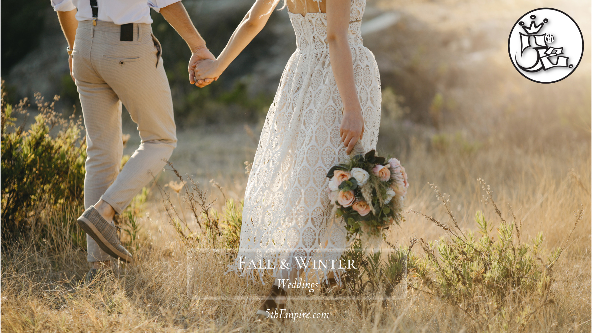 Couple walking hand in hand during the fall. Bride has a bouquet in hand.